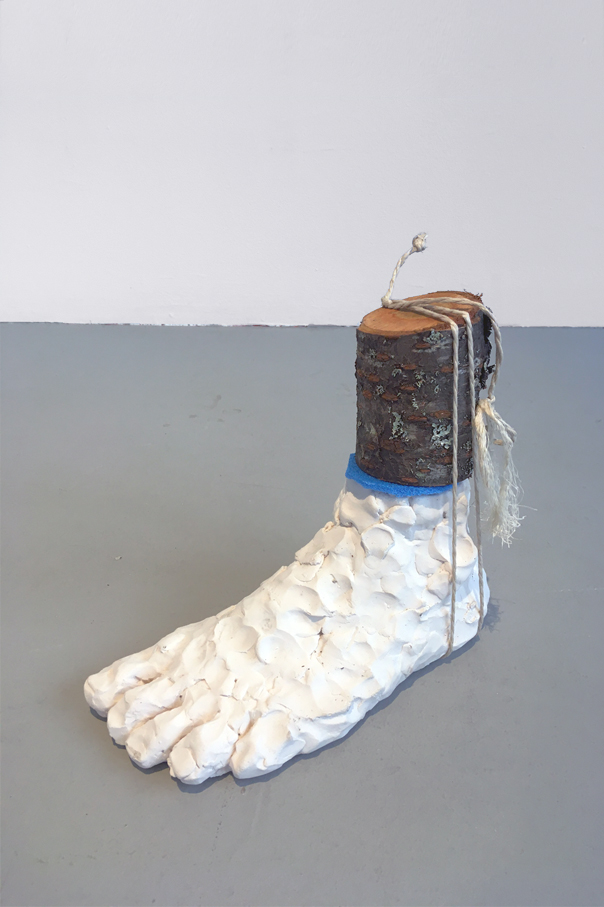 One foot sculpted in clay and wood